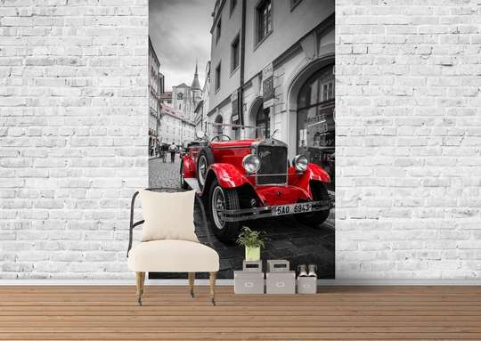 Wall Mural - Red car on a black and white city background.