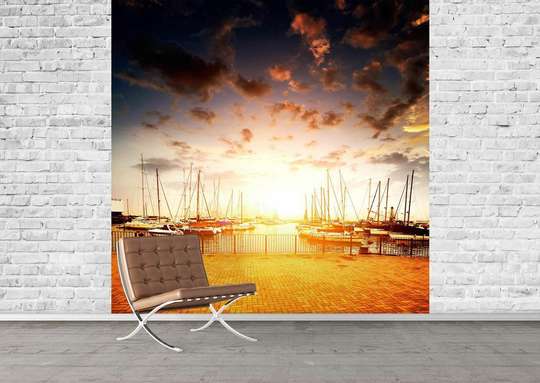 Wall mural with a view of the shore and boats at sunset.